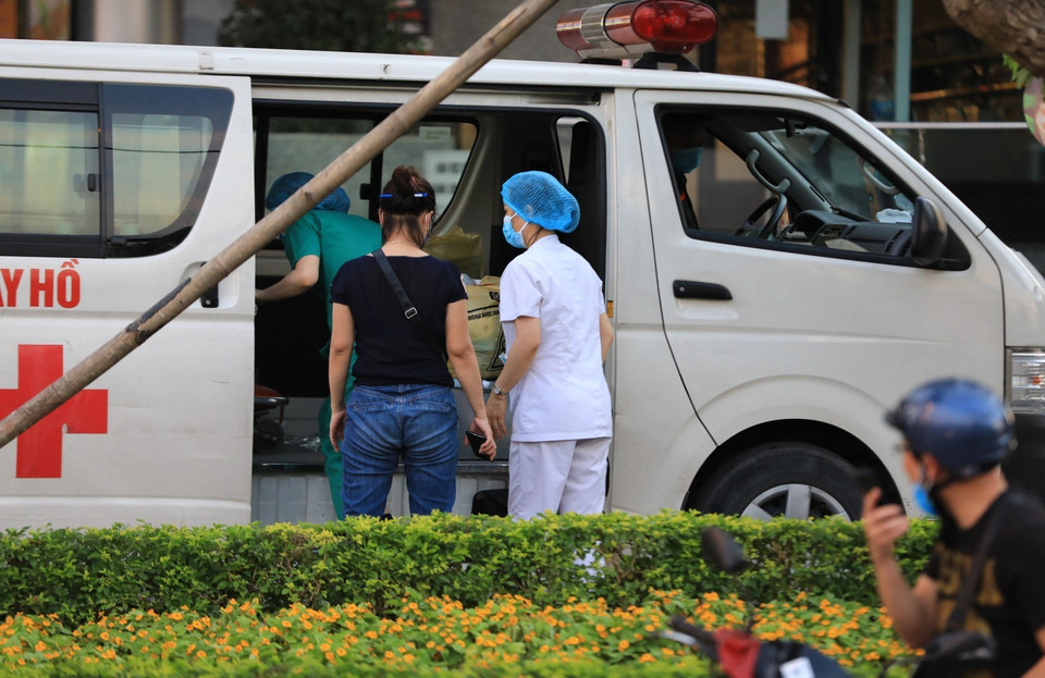 Chiều 29/5, lực lượng chức năng Trung tâm Y tế quận Tây Hồ có mặt tại tòa nhà Fraser Suites để tiến hành các thủ tục đưa bệnh nhân đi cách ly y tế tập trung. (Ảnh: Thành Đạt/TTXVN)