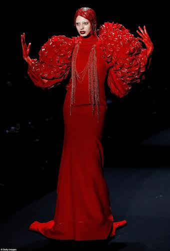 Người mẫu mặc váy đỏ với phần ống tay phồng lớn ấn tượng và hai bàn tay vấy máu. (Nguồn: Daily Mail)