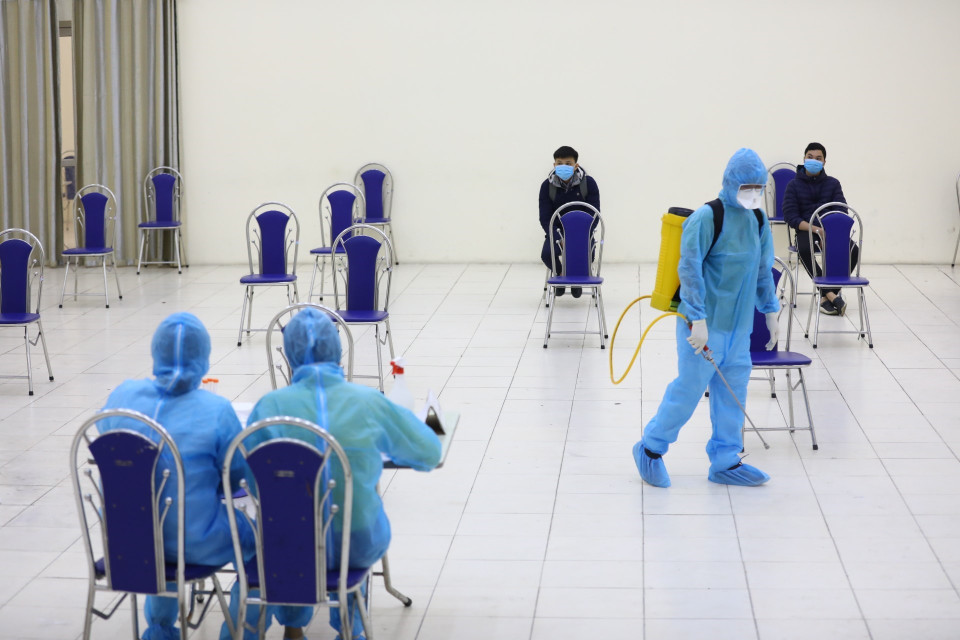 Phun thuốc khử trùng tại khu vực lấy mẫu Nhà văn hoá phường Quan Hoa, quận Cầu Giấy. (Ảnh: Huy Hùng/TTXVN)