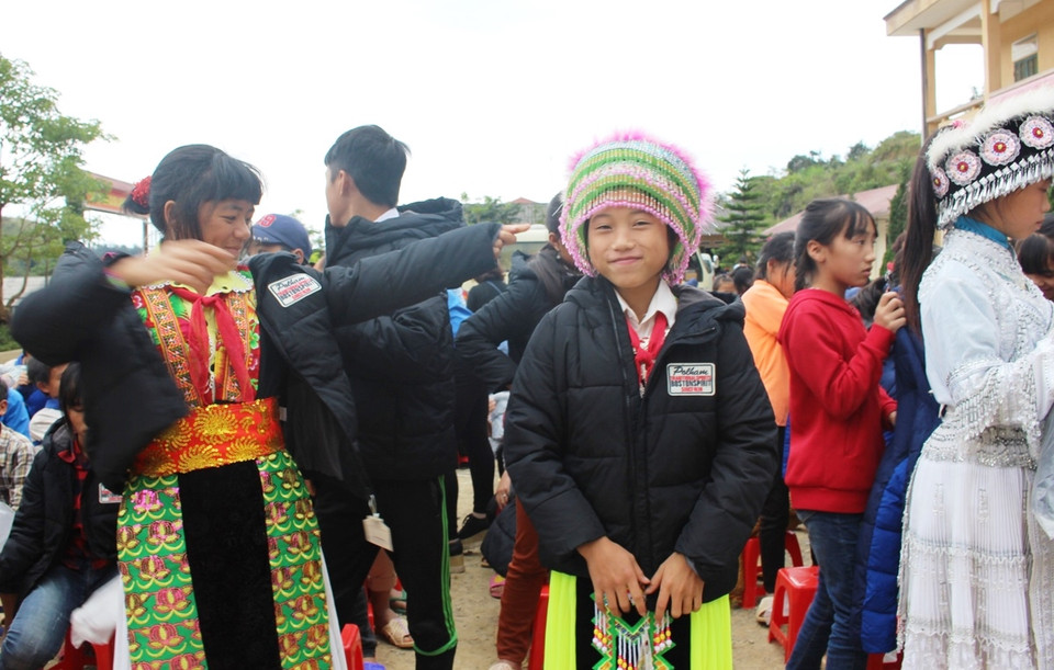 Các em học sinh Trường phổ thông bán trú trung học cơ sở Tả Ván vui cười khi được mặc áo ấm. (Ảnh: Hùng Võ/Vietnam+)