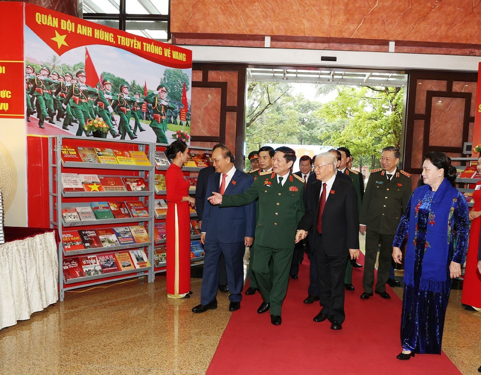 Tổng Bí thư, Chủ tịch nước, Bí thư Quân ủy Trung ương Nguyễn Phú Trọng và các đại biểu tham quan khu trưng bày các ấn phẩm quốc phòng. (Ảnh: Trí Dũng/TTXVN)