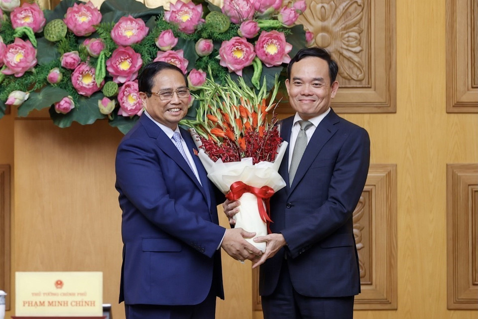 Thủ tướng Phạm Minh Chính tặng hoa chúc mừng Phó Thủ tướng Trần Lưu Quang được Bộ Chính trị điều động, phân công giữ chức Trưởng Ban Kinh tế Trung ương. (Ảnh: Dương Giang/TTXVN)