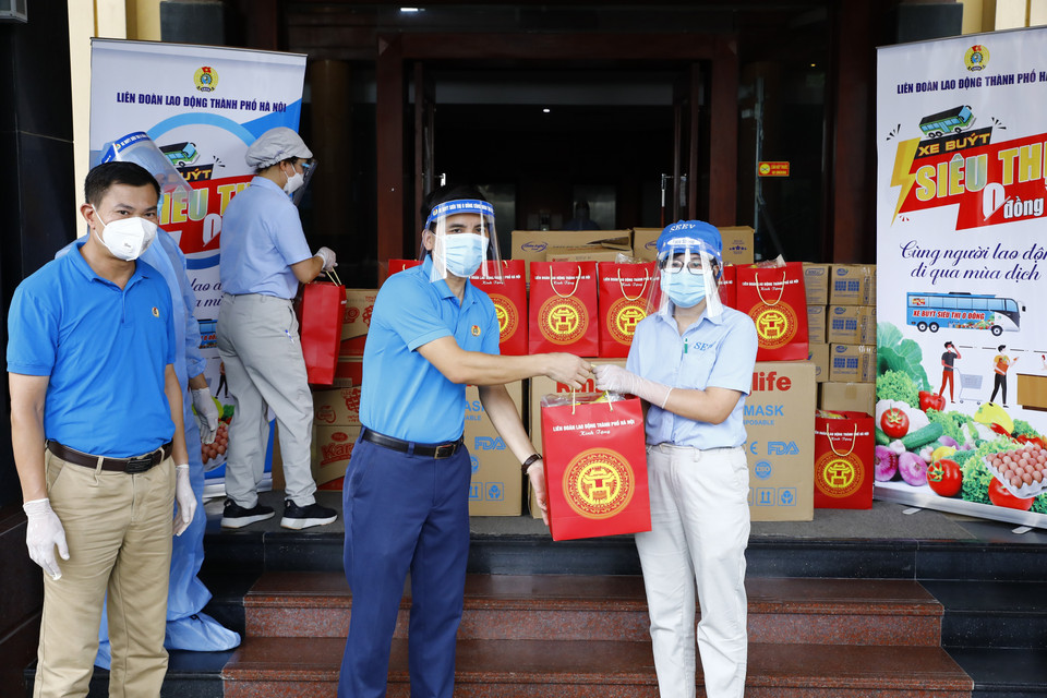 Phó Chủ tịch Liên đoàn Lao động thành phố Hà Nội Lê Đình Hùng trao quà cho công nhân đang cách ly tại khách sạn Hà Anh. (Ảnh: Minh Đức/TTXVN)