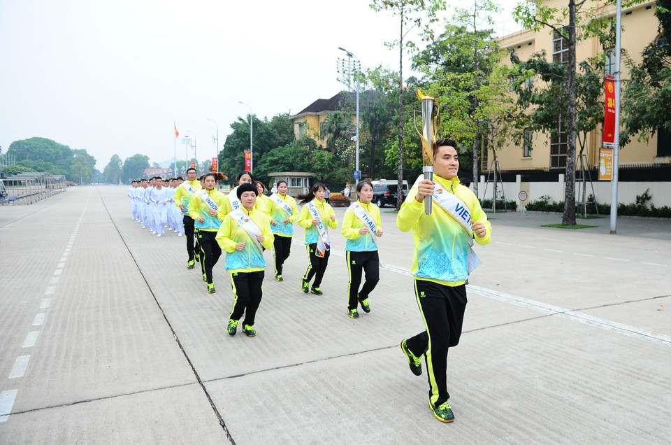 11 vận động viên tiêu biểu tham dự rước đuốc. (Ảnh: Minh Đức/TTXVN)