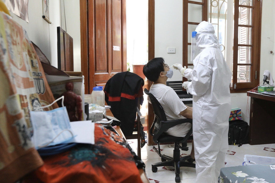 Nhân viên y tế quận Hoàn Kiếm đến lấy mẫu tại hộ gia đình có người tự cách ly liên quan đến trường hợp mắc COVID-19 (ảnh chụp 31/5/2021). (Ảnh: Minh Quyết/TTXVN)