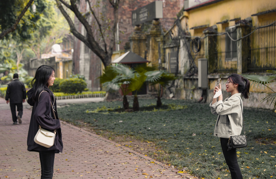 Nhiều bạn trẻ đưa đi nhau ngắm phố phường mùa thay lá, tranh thủ chụp những bức hình kỷ niệm trong những ngày Hà Nội bình yên. (Ảnh: Minh Hiếu/Vietnam+)