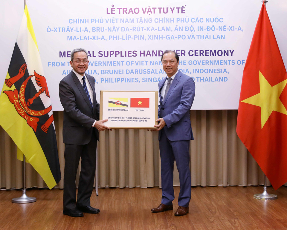 Thứ trưởng Bộ Ngoại giao Nguyễn Quốc Dũng trao tượng trưng hỗ trợ vật tư y tế cho Chính phủ và nhân dân Brunei Darussalam phòng, chống COVID-19. (Ảnh: Văn Điệp/TTXVN)