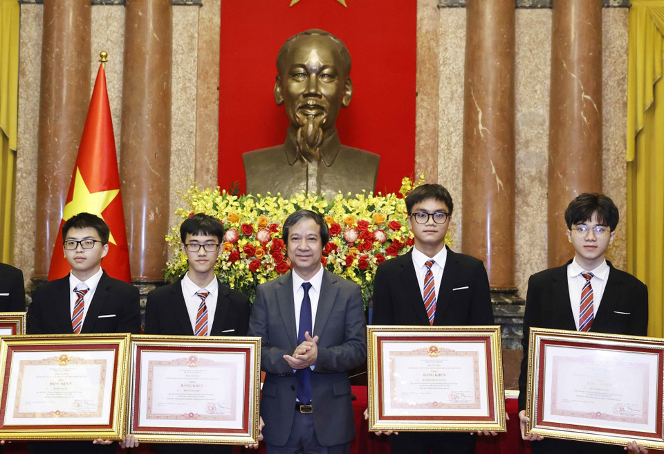 Bộ trưởng Bộ Giáo dục và Đào tạo Nguyễn Kim Sơn trao Bằng khen của Thủ tướng Chính phủ cho học sinh đoạt giải các cuộc thi Olympic và Khoa học kỹ thuật quốc tế năm 2022. (Ảnh: Thống Nhất/TTXVN)