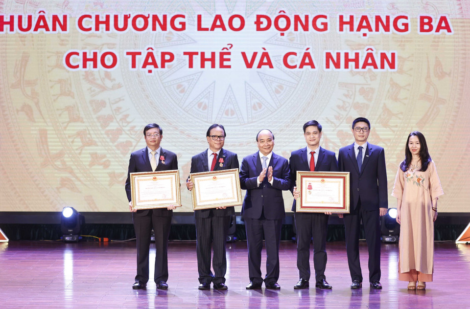 Chủ tịch nước Nguyễn Xuân Phúc trao tặng Huân chương Lao động hạng Ba cho tập thể và các nhân của Trường Đại học Kinh tế Quốc dân. (Ảnh: Thống Nhất/TTXVN)