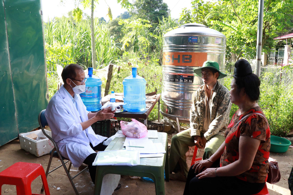 Nhân viên y tế cấp phát thuốc điều trị các bệnh ngoài da, truyền nhiễm cho người dân vùng ngập úng ở bản Giáng. (Ảnh: Hữu Quyết/TTXVN)