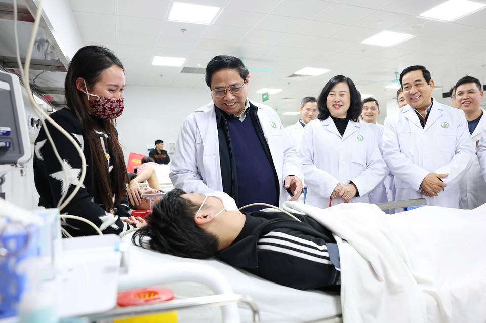 Thủ tướng Phạm Minh Chính động viên bệnh nhân đang điều trị tại Bệnh viện Hữu nghị Việt Đức. (Ảnh: Dương Giang/TTXVN)