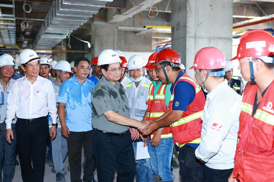 Thủ tướng Phạm Minh Chính với kỹ sư, công nhân thi công Dự án xây dựng nhà ga hành khách T3-Cảng hàng không quốc tế Tân Sơn Nhất. (Ảnh: Dương Giang/TTXVN)
