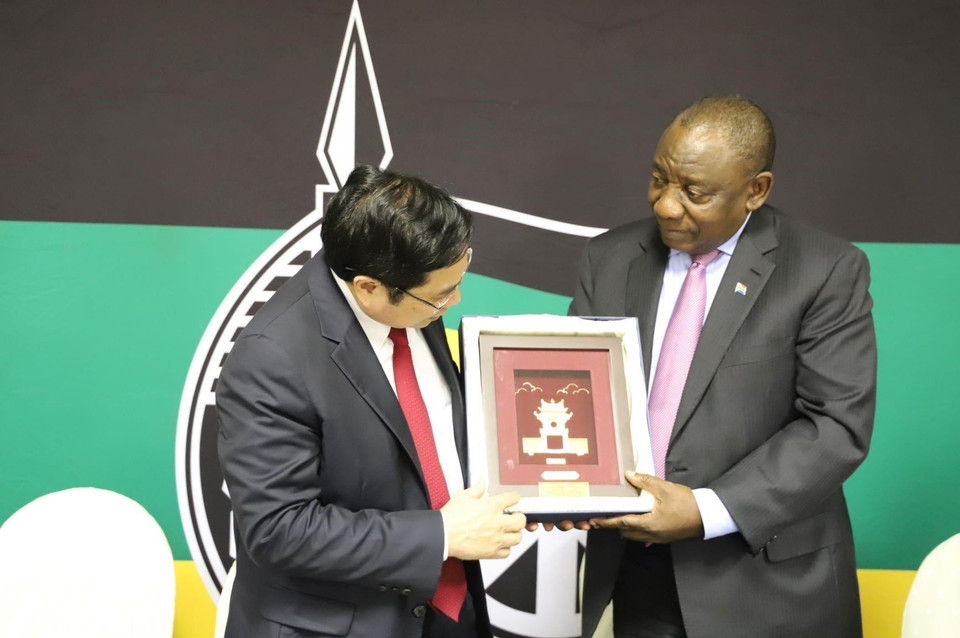 Trưởng ban Tổ chức Trung ương Phạm Minh Chính tặng quà lưu niệm cho Chủ tịch Đảng Đại hội Dân tộc Phi (ANC) Cyril Ramaphosa. (Ảnh: Phi Hùng/TTXVN)