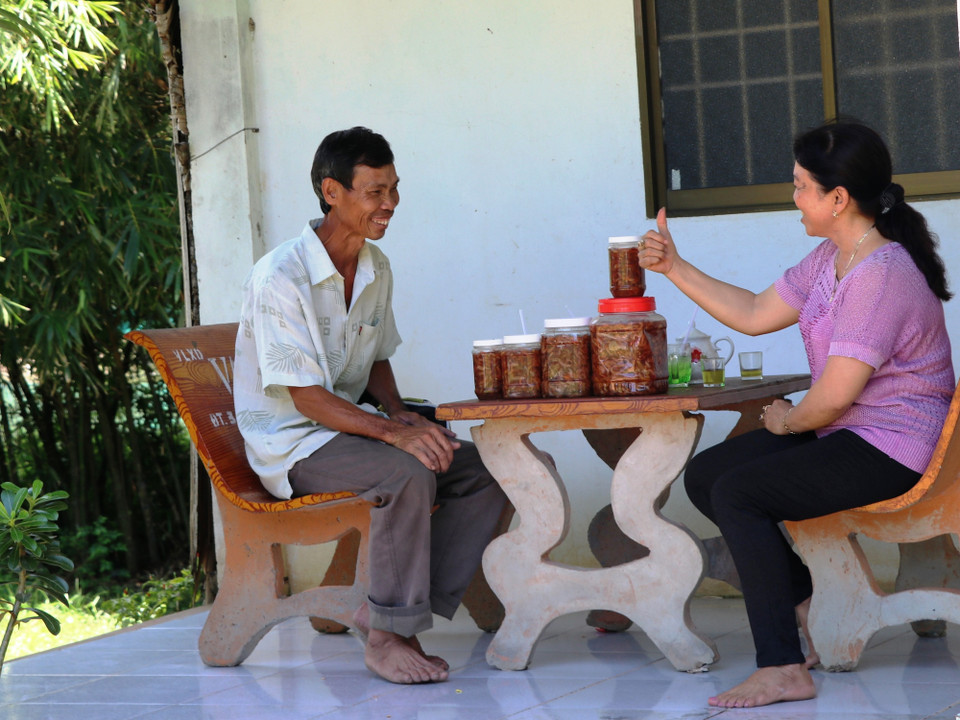 Anh Lê Văn Miền hào hứng và tâm đắc khi lắng nghe vợ mình thuyết trình về kế hoạch làm mắm tôm chua để tăng thêm thu nhập cho gia đình. (Ảnh: PV/Vietnam+)