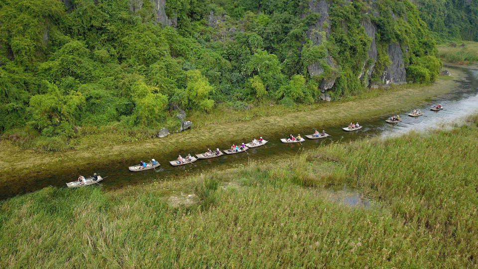 Du khách trong và ngoài nước tham quan khu bảo tồn thiên nhiên đất ngập nước Vân Long bằng thuyền. (Ảnh: Minh Đức/TTXVN)