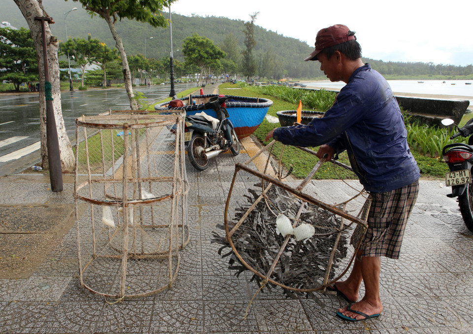 Ngư dân Đà Nẵng vận chuyển các ngư lưới cụ vào sâu đất liền để tránh bão Noru. (Ảnh: Trần Lê Lâm/TTXVN)