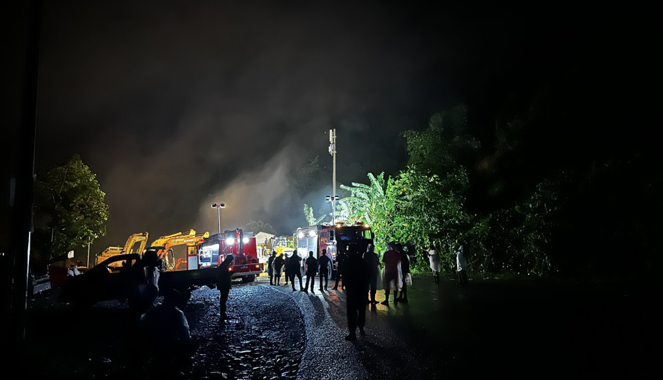 Lực lượng với khoảng 100 người và nhiều xe cơ giới tiếp tục làm việc xuyên đêm để tìm kiếm nạn nhân thứ 4 trong vụ sạt lở trên đèo Bảo Lộc. (Ảnh: Nguyễn Dũng/TTXVN)