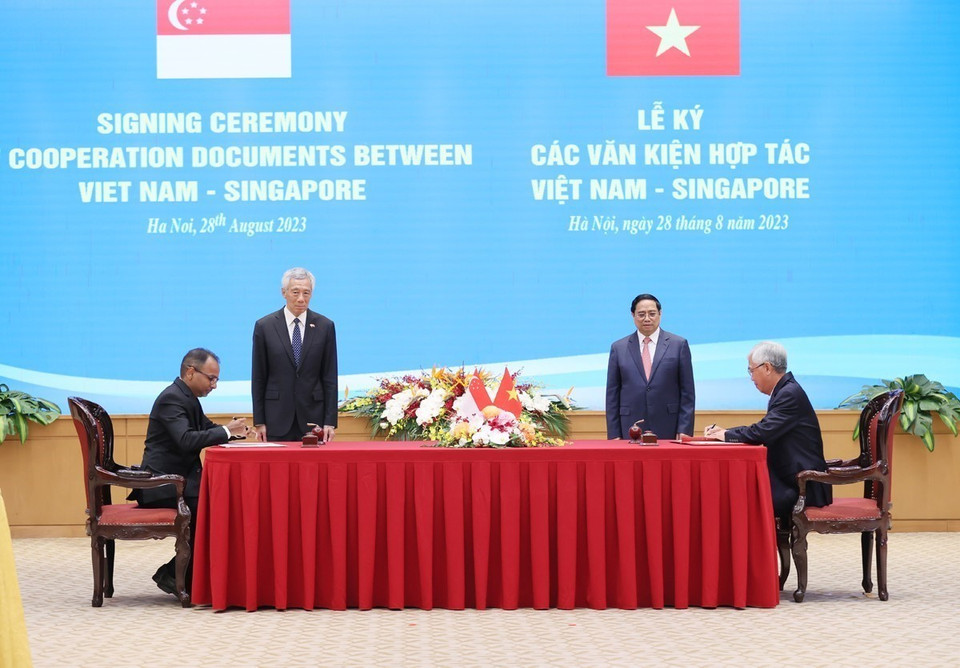 Thủ tướng Phạm Minh Chính và Thủ tướng Singapore Lý Hiển Long chứng kiến ký Bản ghi nhớ về thúc đẩy phát triển cơ sở hạ tầng bền vững tại Thành phố Hồ Chí Minh giữa Ủy ban Nhân dân Thành phố Hồ Chí Minh và Cơ quan Hạ tầng châu Á, Singapore. (Ảnh: Dương Giang/TTXVN)