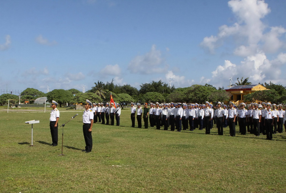 Quân và dân trên đảo Song Tử Tây thực hiện nghi lễ chào cờ đầu năm. (Ảnh: Dương Giang/TTXVN)