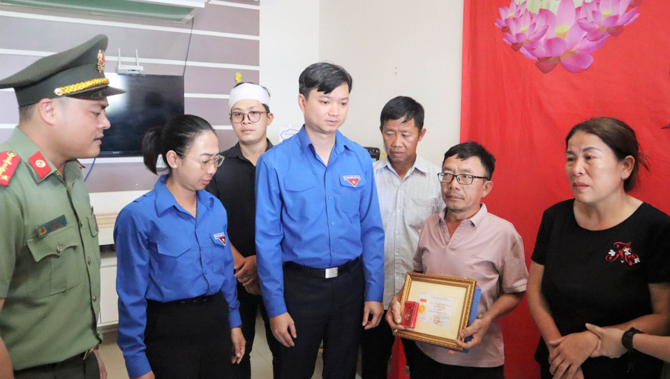 Trung ương Đoàn truy tặng Huy hiệu Tuổi trẻ Dũng cảm cho liệt sỹ, Đại úy Nguyễn Đăng Nhân đến gia đình chiến sỹ. (Ảnh: Hoài Thu/TTXVN)
