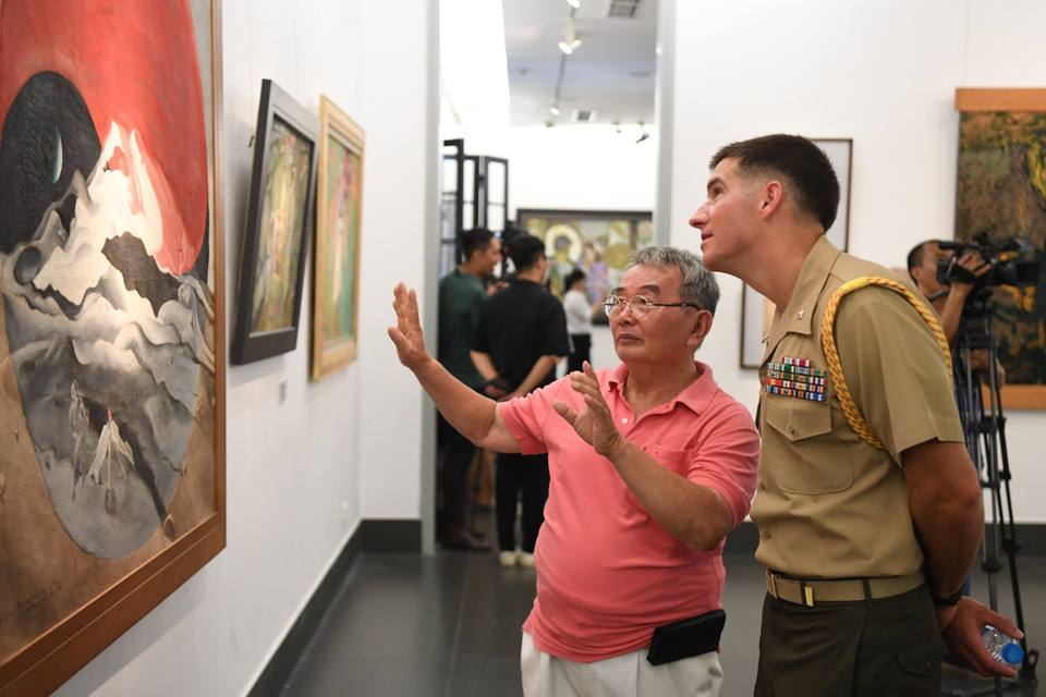 'Những bức tranh trong buổi triển lãm tại đây rất thú vị và thực sự đa dạng, nó đã khắc họa chân thực các sự kiện và khoảnh khắc của con người và chiến sỹ Việt Nam trong thời chiến. Tôi bất ngờ khi có những tác phẩm vẽ tại Mỹ. Tôi nghĩ rằng triển lãm lần này thể hiện đúng tinh thần của ngày ngày lễ 27/7 nhằm bày tỏ lòng kính trọng đối với những người đã hy sinh cho đất nước Việt Nam,' Trung tá Chad Summerville, Tùy viên Thủy quân Lục chiến, Đại sứ quán Mỹ bày tỏ quan điểm. (Ảnh: Minh Hiếu/Vietnam+)
