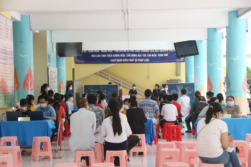 Điểm tiêm tại trường Tiểu học Nguyễn Bỉnh Khiêm (Quận 1) diễn ra trật tự, nghiêm túc, an toàn. (Ảnh: Thu Hương/TTXVN)