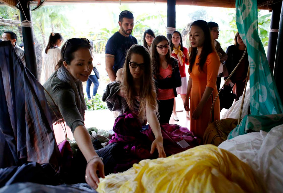 Khách tham quan, tìm hiểu về sản phẩm tơ lụa của các làng nghề lụa Việt Nam. (Nguồn: Trần Lê Lâm/Vietnam+)