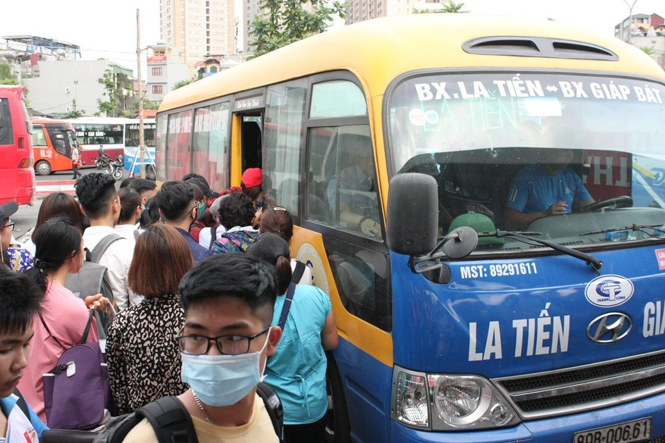 Mỗi khi xe vào khu vực chờ, hành khách ào ào lên xe nhằm kiếm cho mình một chỗ ngồi dễ thở trong dịp nghỉ lễ này. (Ảnh: Việt Hùng/Vietnam+)