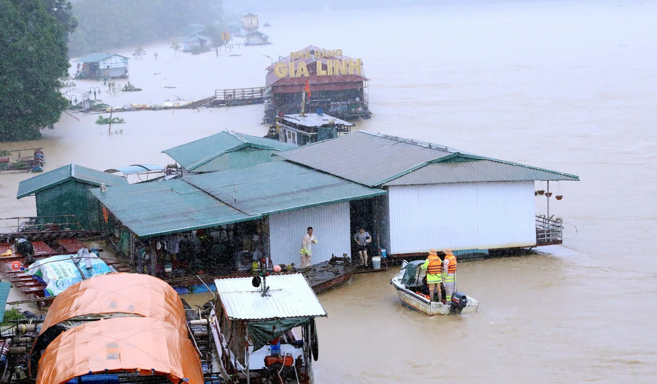 Lực lượng cảnh sát giao thông đường thủy cứu hộ, đưa người dân ra khỏi khu vực nguy hiểm. (Ảnh: Quang Cường/TTXVN)