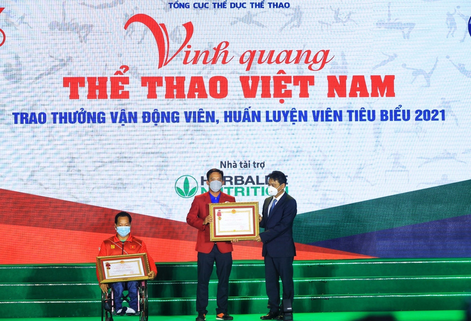 Thừa ủy quyền của Chủ tịch nước, Thứ trưởng Bộ Văn hóa, Thể thao và Du lịch Hoàng Đạo Cương trao Huân chương Lao động hạng Nhì, Ba cho vận động viên Lê Văn Công và huấn luyện viên Lê Quang Thái. (Ảnh: Tuấn Anh/TTXVN)
