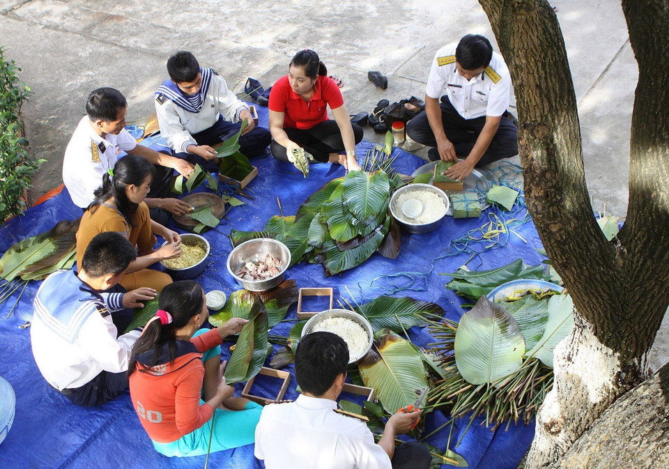 Quân và dân đảo Sinh Tồn gói bánh chưng đón Tết. (Ảnh: Dương Giang/ TTXVN)