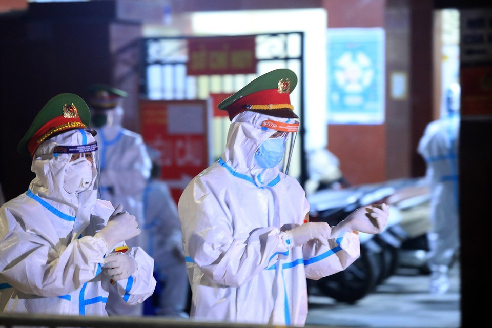 Lực lượng Công an phường Thanh Xuân Trung hỗ trợ người dân di chuyển. (Ảnh: Tuấn Anh/TTXVN)