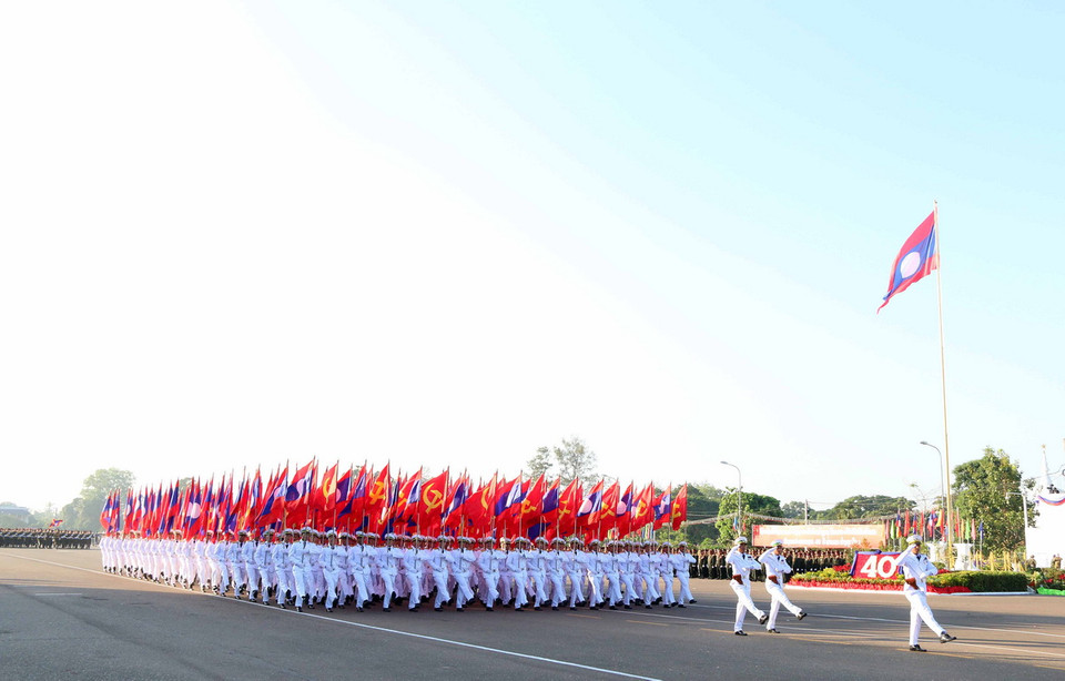 Khối cờ Đảng và Quốc kỳ đang tiến qua lễ đài. (Ảnh: Phạm Kiên/Vietnam+)