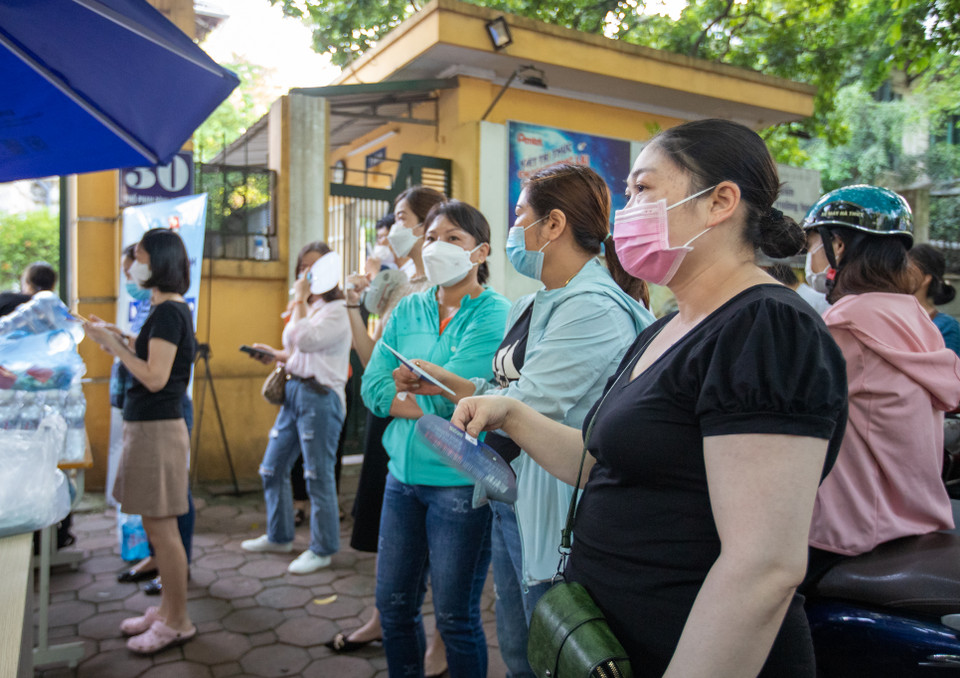 Các bậc phụ huynh nôn nóng chờ con ngoài cổng trường. (Ảnh: PV/Vietnam+)