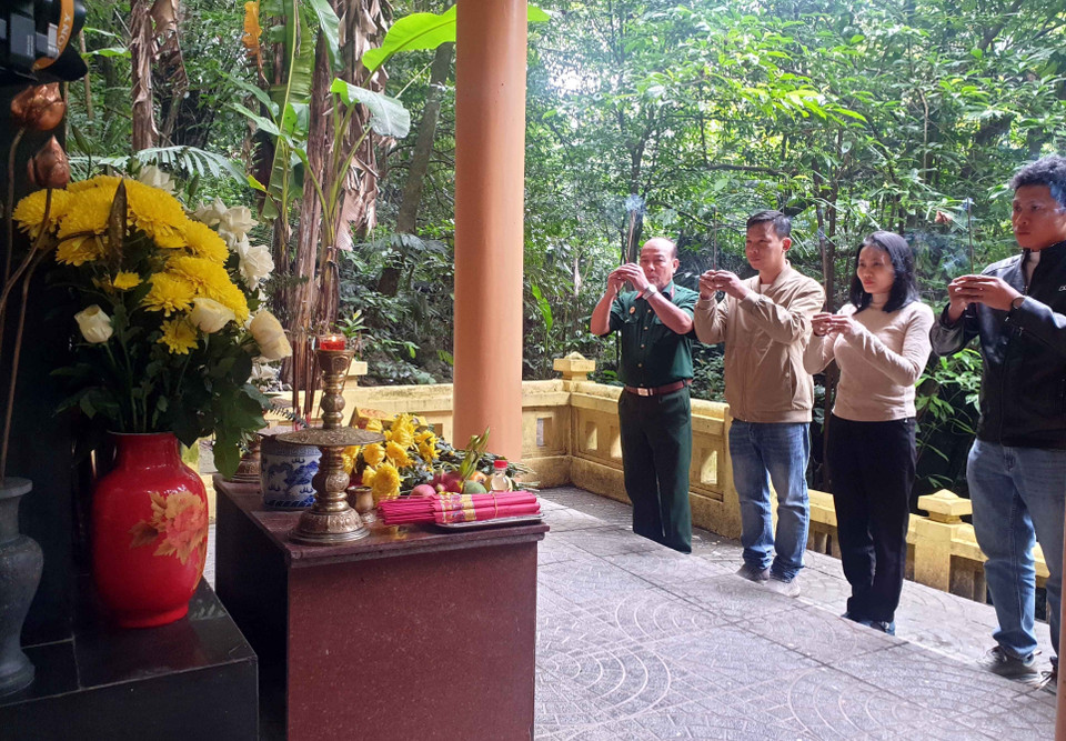 Du khách dâng hương tại bia Cô Y tá trên "Hành trình đi tìm dấu ấn Trường Sơn huyền thoại." (Ảnh: Tá Chuyên/TTXVN)