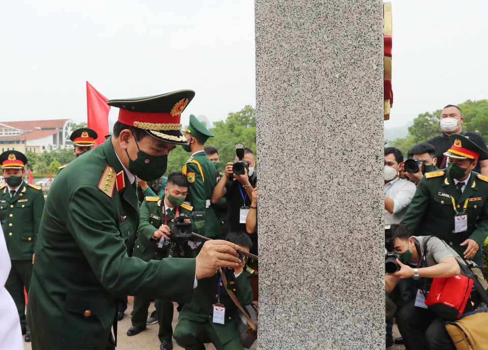 Bộ trưởng Quốc phòng Phan Văn Giang tô sơn cột mốc biên giới Việt Nam tại cửa khẩu Tà Lùng. (Ảnh: Trọng Đức/TTXV)N