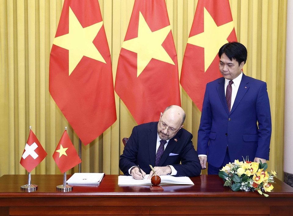 Đại sứ Thụy Sỹ Thomas Gass viết lưu bút tại Phủ Chủ tịch. (Ảnh: Thống Nhất/TTXVN)