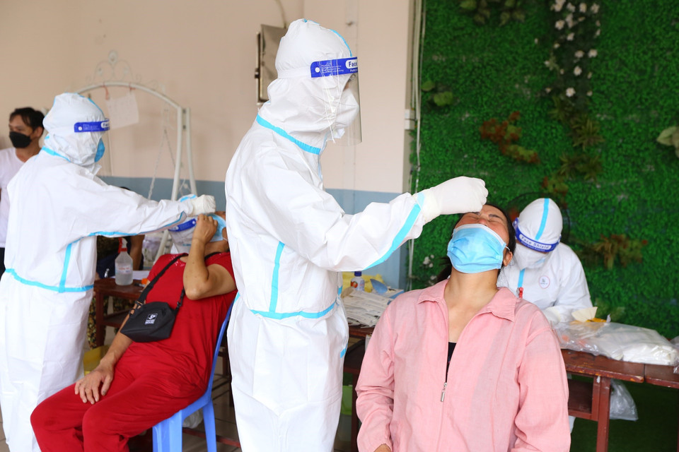 Lực lượng y tế lấy mẫu xét nghiệm COVID-19 cho tiểu thương chợ Hà Đông, sáng 24/8. (Ảnh: Hoàng Hiếu/TTXVN)