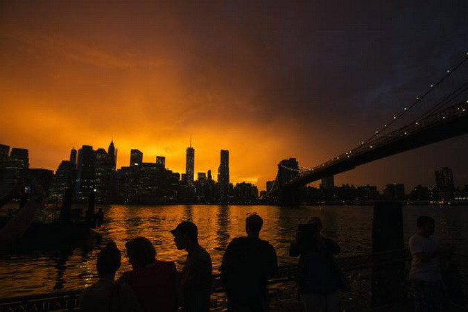 Người dân xếp hàng trên một bến tàu ở Brooklyn để ngắm cảnh mặt trời lặn. (Nguồn: Reuters)