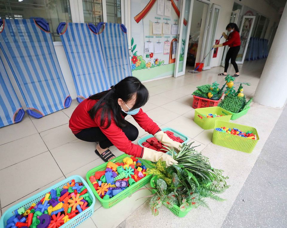 Giáo viên trường mầm non Thịnh Liệt (quận Hoàng Mai (Hà Nội)) vệ sinh, khử khuẩn không gian trường, lớp, đồ dùng dạy học, đồ chơi cho trẻ... (Ảnh: Thanh Tùng/TTXVN)