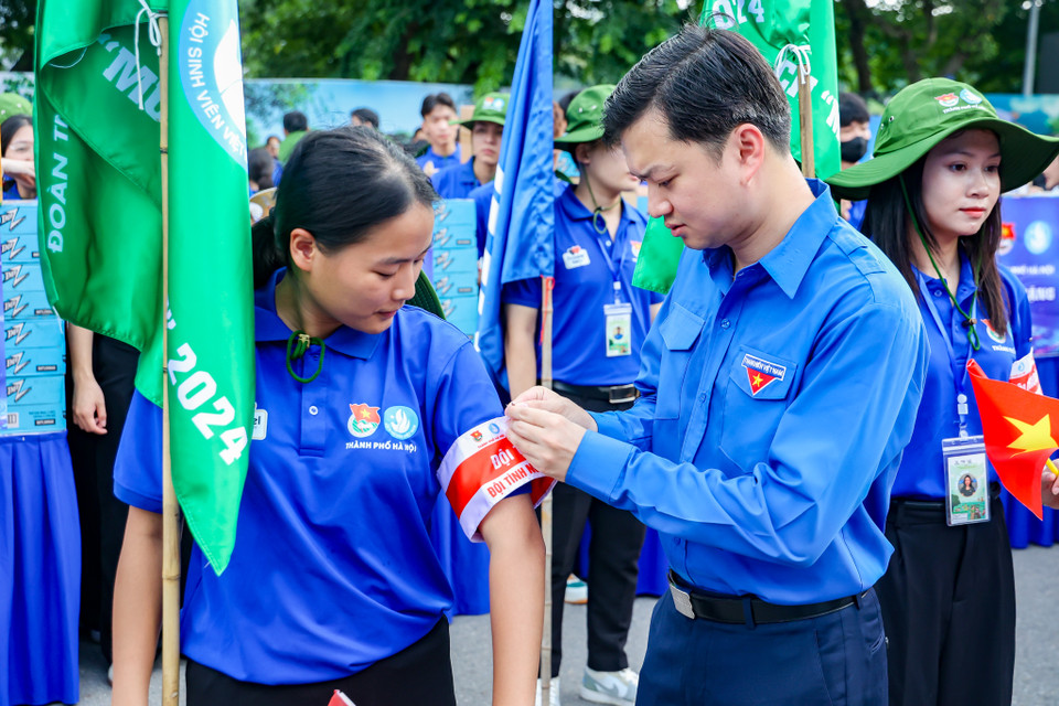 Sau màn giới thiệu các đội hình, Đồng chí Nguyễn Minh Triết trao băng đội trưởng cho các đội tình nguyện. (Ảnh: Minh Hiếu/Vietnam+)