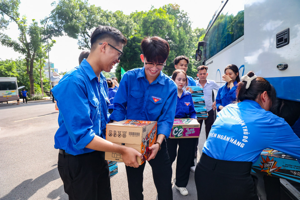 Các bạn sinh viên tình nguyện vận chuyển các vật phẩm thiết yếu lên xe để xuất phát đến các điểm hỗ trợ làm nhiệm vụ. (Ảnh: Minh Hiếu/Vietnam+)