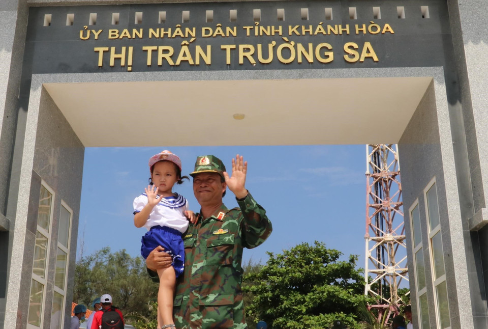 Thiếu tướng, Phó giáo sư, tiến sỹ, bác sỹ, Thầy thuốc nhân dân Nguyễn Hồng Sơn - Giám đốc Bệnh viện Quân y 175, cùng một công dân nhí trên thị trấn Trường Sa. (Ảnh: Sỹ Tuyên/TTXVN)