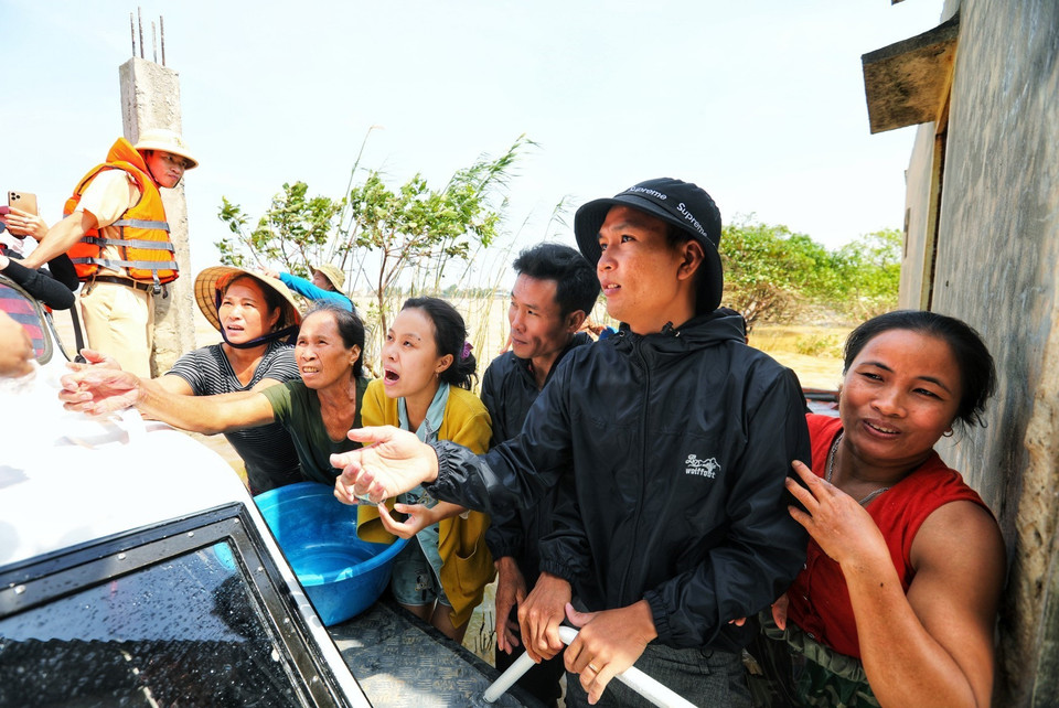 Niềm vui của người dân thôn Phú Thọ, xã An Thủy, huyện Lệ Thủy khi có đoàn đến cứu trợ. (Ảnh: Thành Đạt/TTXVN)