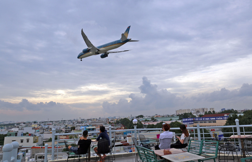 Máy bay xẹt qua đầu, tiếng gầm rú phát ra từ động cơ không làm giảm đi sở thích ngắm máy bay của người dân. (Ảnh: Huy Hùng/TTXVN)