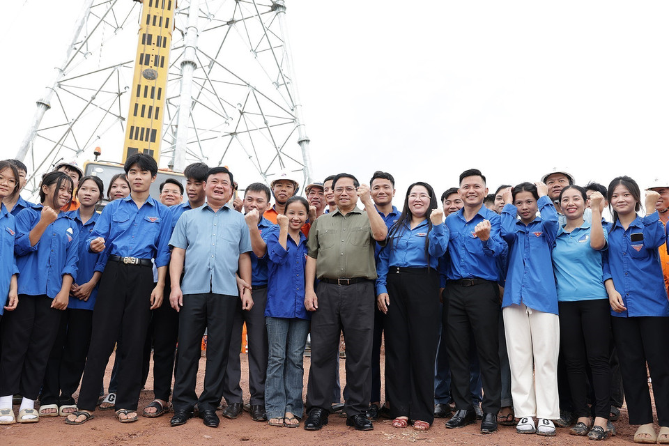 Thủ tướng Phạm Minh Chính với thanh niên trên công trường dự án đường dây tải điện 500kV mạch 3 đoạn qua tỉnh Nghệ An. (Ảnh: Dương Giang/TTXVN)