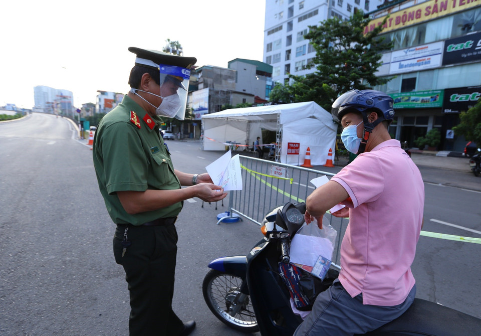 Từ 6h sáng, lực lượng chức năng đã kiểm soát chặt giấy đi đường của người dân (ảnh chụp tại chốt cầu Vĩnh Tuy). (Ảnh: Hoàng Hiếu/TTXVN)