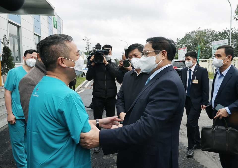 Thủ tướng Phạm Minh Chính thăm hỏi , động viên các y, bác sỹ đang điều trị cho các bệnh nhân COVID-19. (Ảnh: Dương Giang/TTXVN)