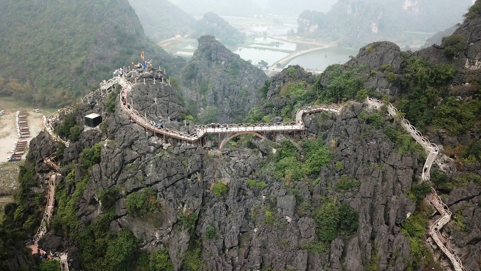 Không chỉ làm những bậc, lan can cầu thang, doanh nghiệp này còn xây dựng một chiếc cầu kiên cố bắc từ đỉnh núi này qua đỉnh núi khác để làm đường đi cho khách. (Ảnh: Minh Đức/TTXVN)