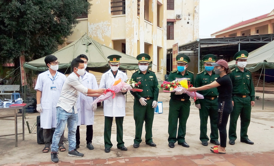 Đại diện Công dân hoàn thành cách ly phòng chống dịch bệnh tặng hoa cám ơn cán bộ chiến sỹ bộ đội biên phòng Quảng Bình đã phục vụ tận tình chu đáo trong suốt thời gian cách ly. (Ảnh: Võ Dung/TTXVN)